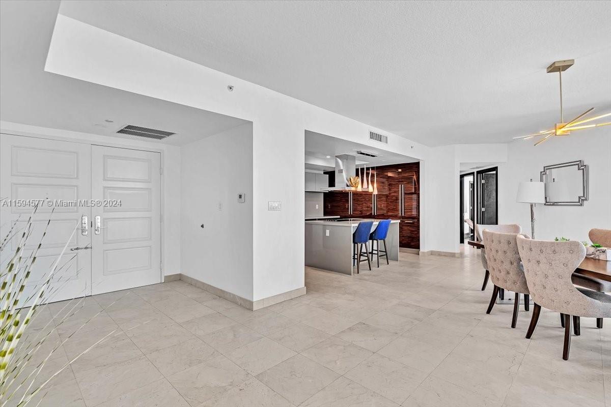 a view of a livingroom with dining room and furniture