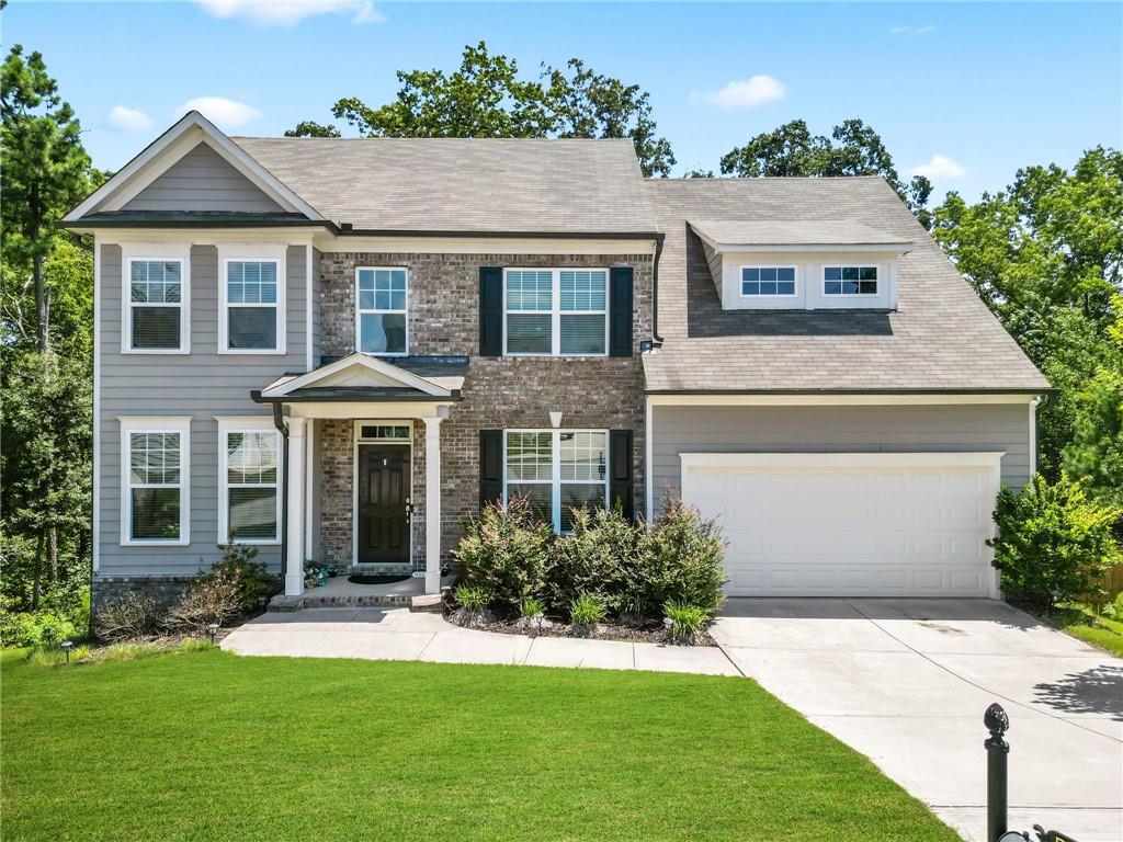 a front view of a house with a yard and garage