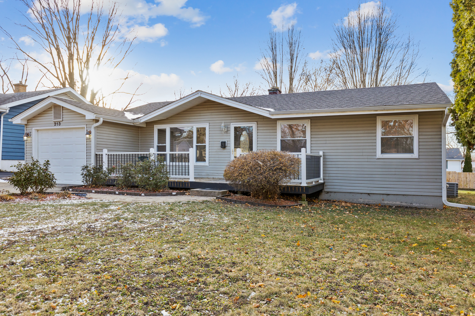 a view of a house with a yard and fence