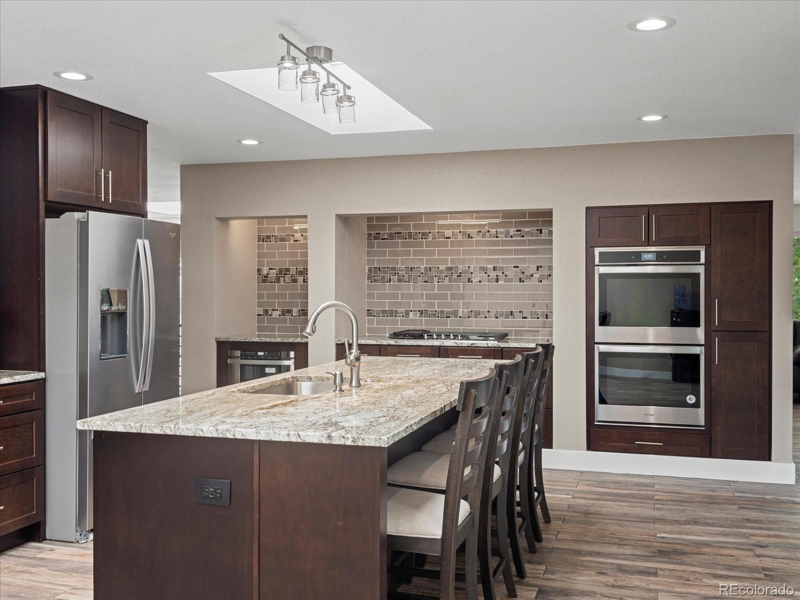 a kitchen with refrigerator cabinets and wooden floor