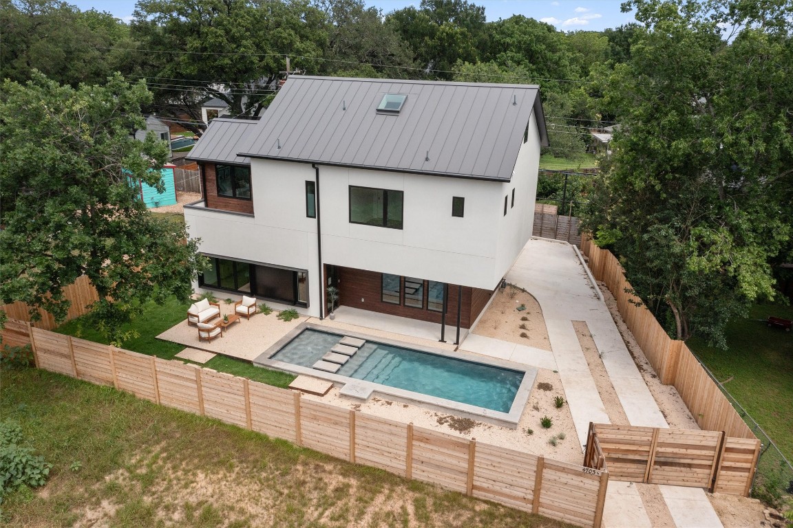 a aerial view of a house with wooden fence