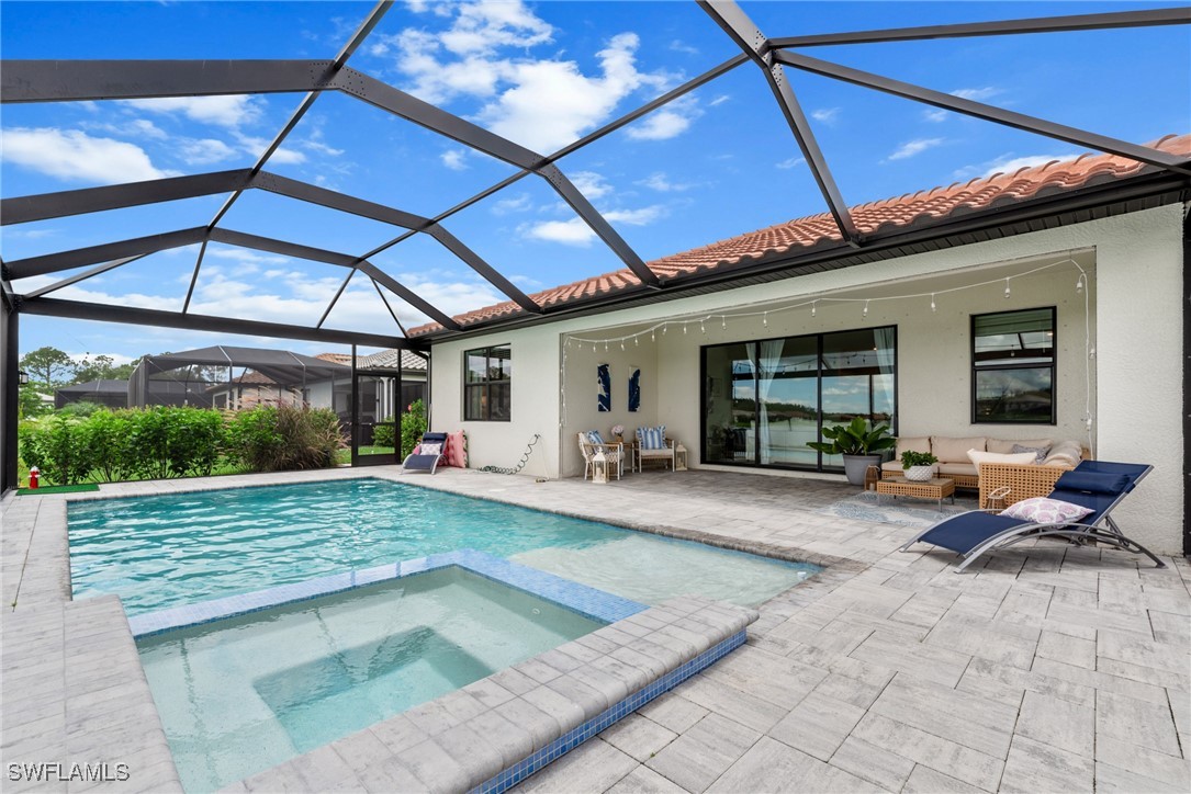 a view of a backyard with table and chairs under an umbrella