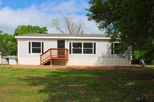 a view of house with backyard