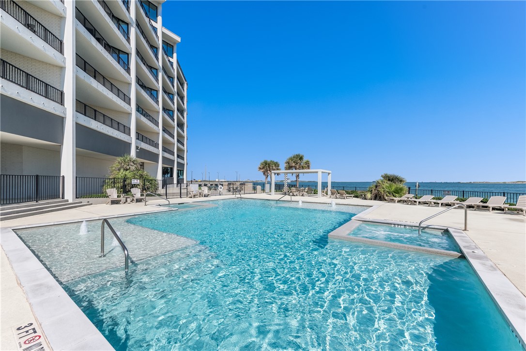 a view of a swimming pool with a lounge chairs