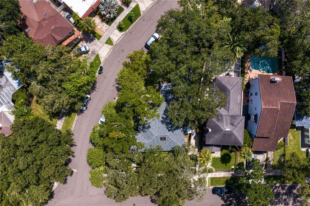 an aerial view of a house with a yard and swimming pool