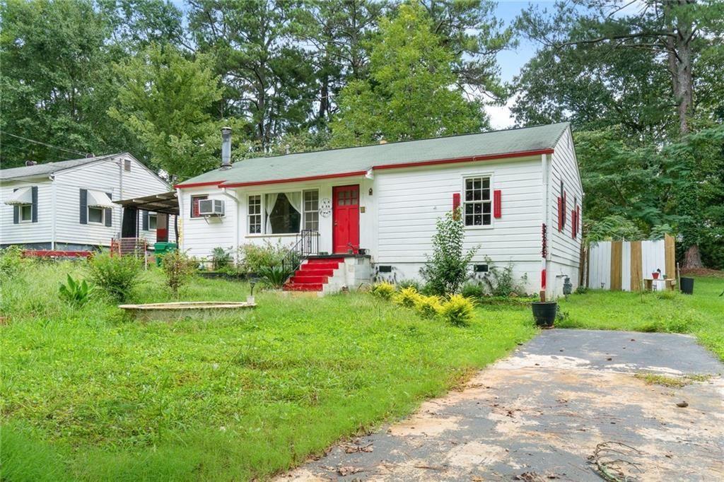 a front view of house with yard and green space