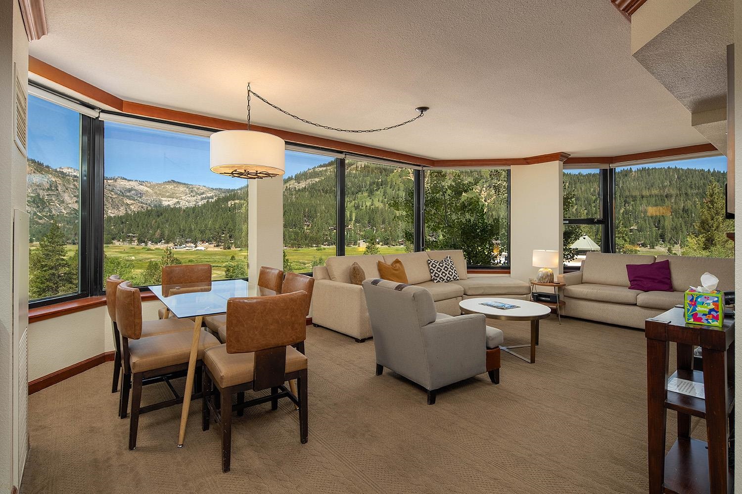 a living room with patio furniture and a floor to ceiling window