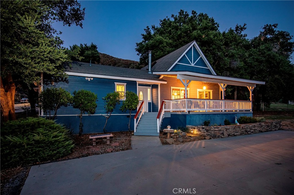 a view of a house with outdoor space and porch