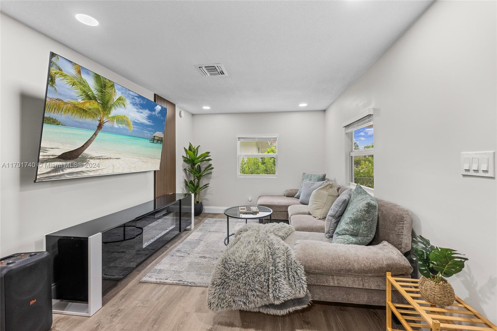 a living room with furniture and painting on the wall