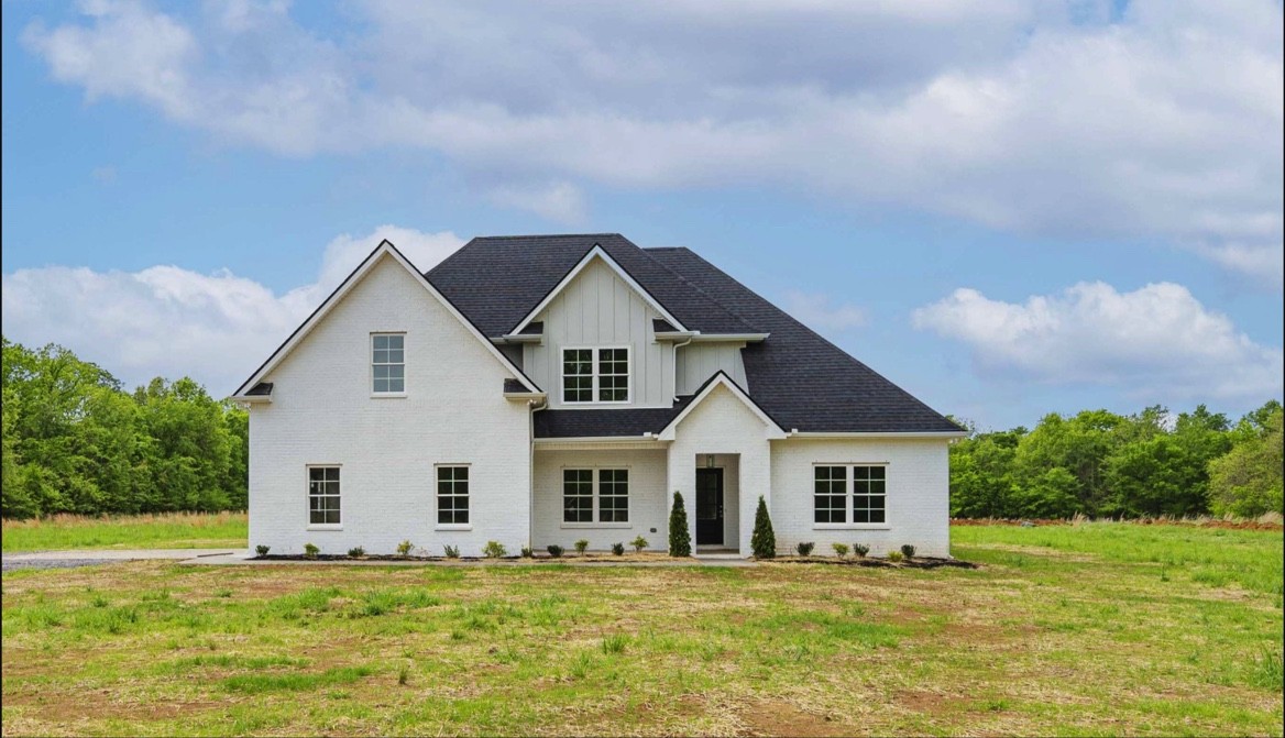 a front view of a house with a yard