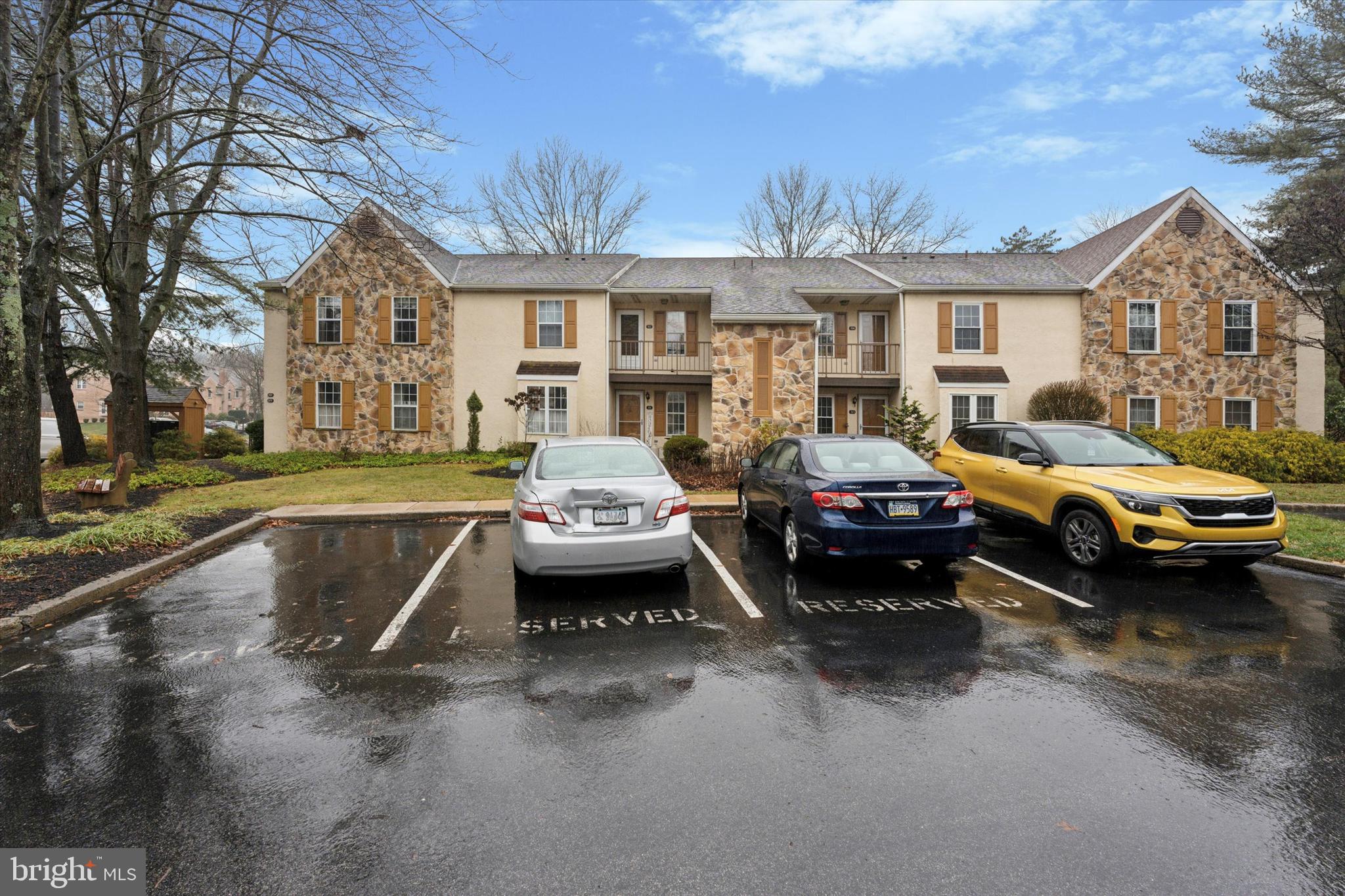 a view of a car parked in front of a brick house