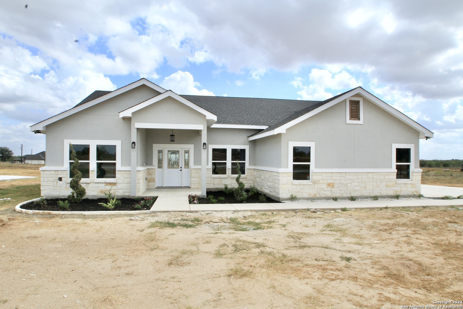 a front view of a house with a yard