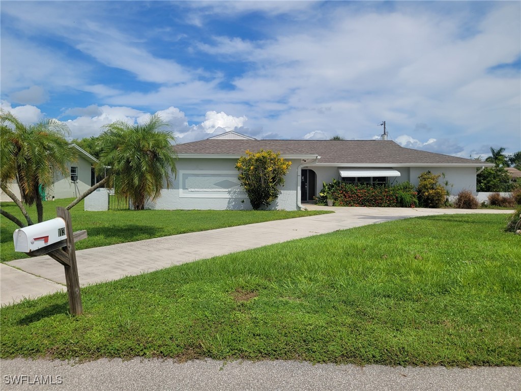 a front view of house with yard and green space