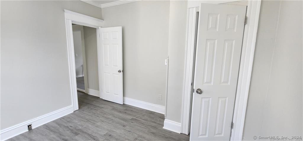 a view of a hallway with wooden floor