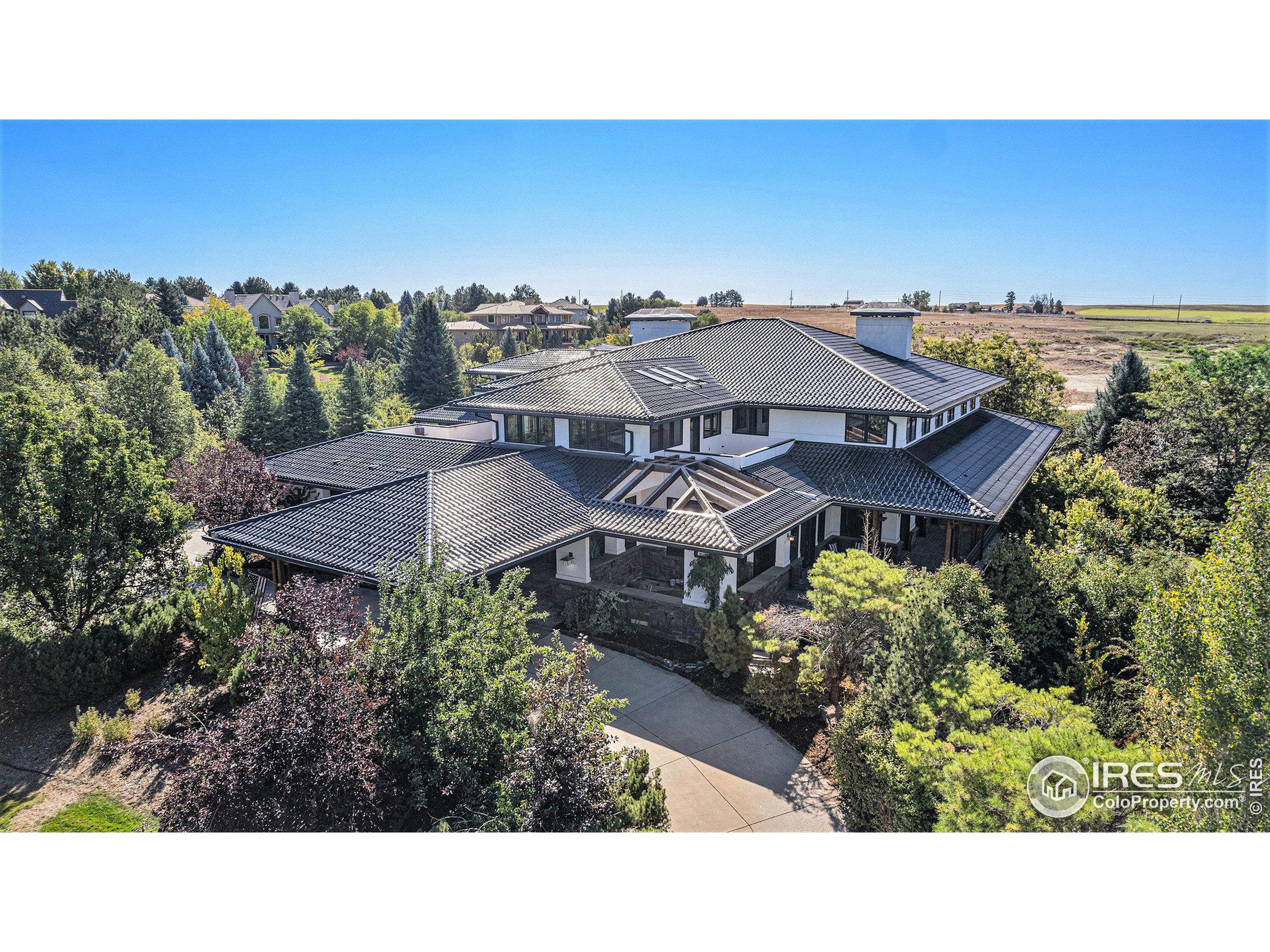 a aerial view of a house with a yard and lake view