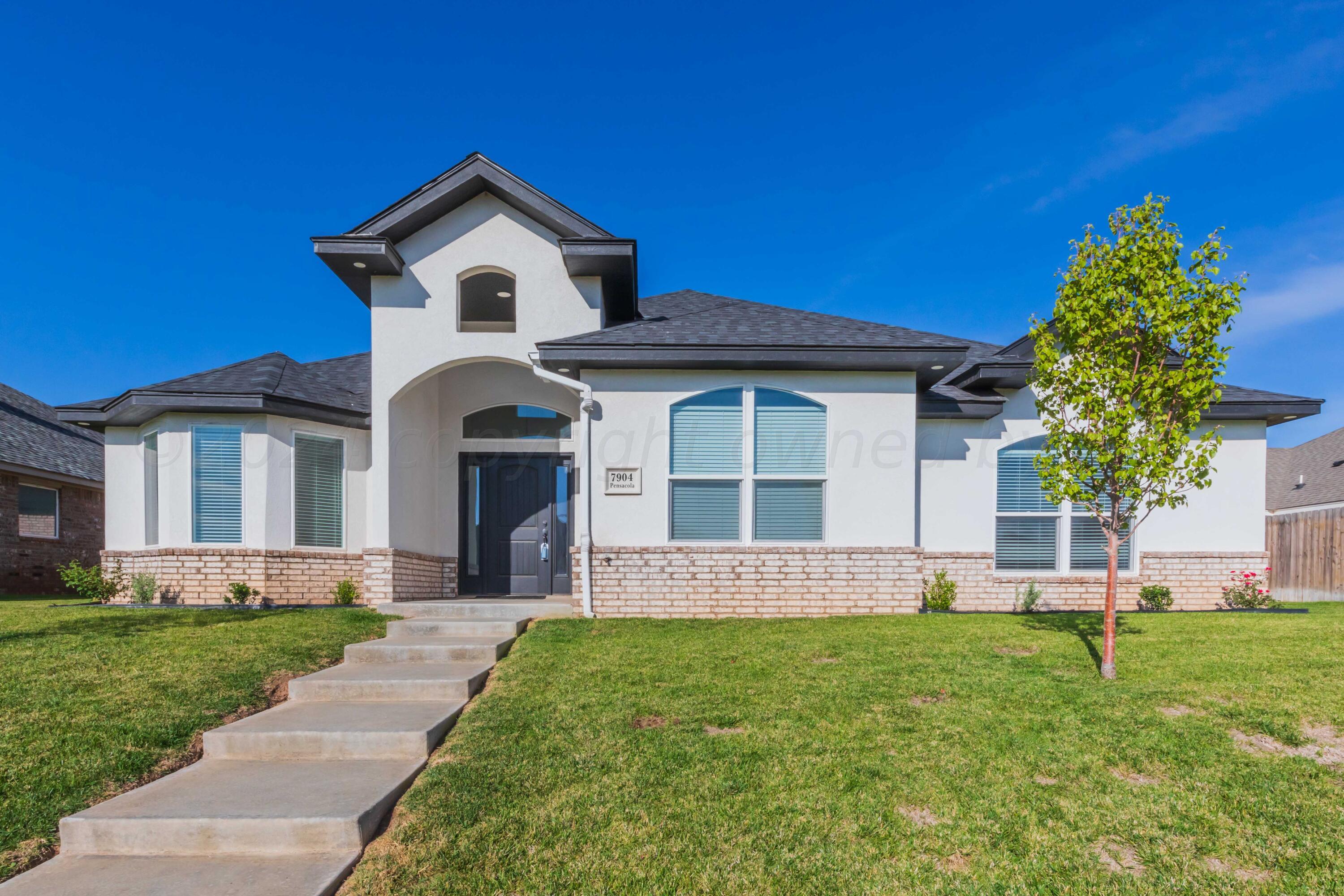 a front view of a house with a yard