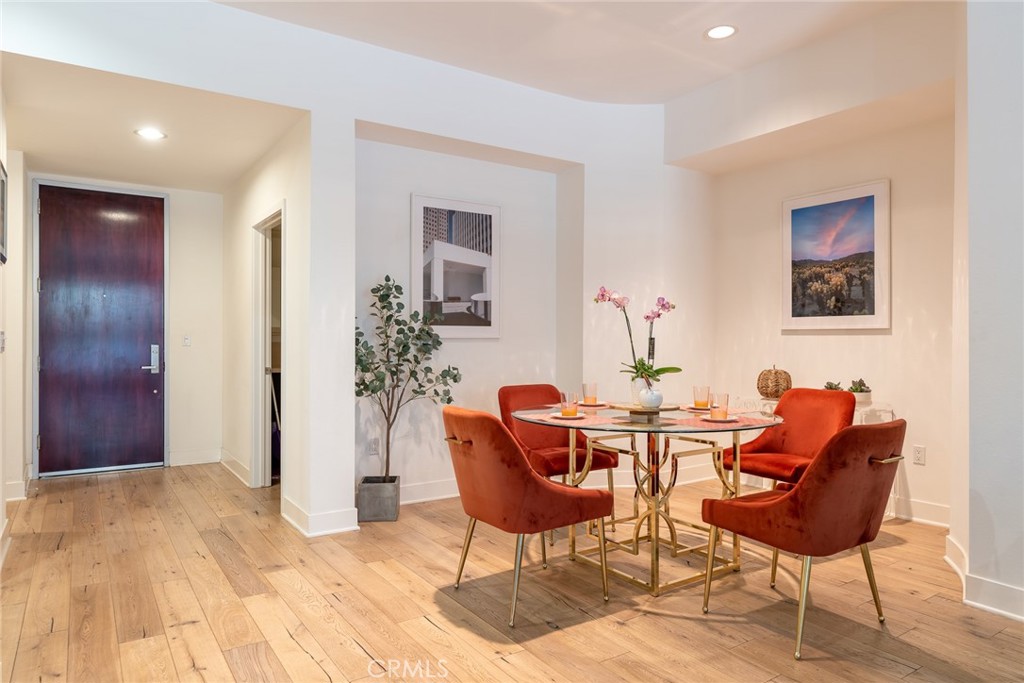 a dining room with furniture and wooden floor