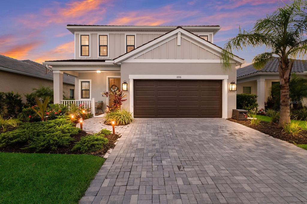 a front view of a house with a yard and garage