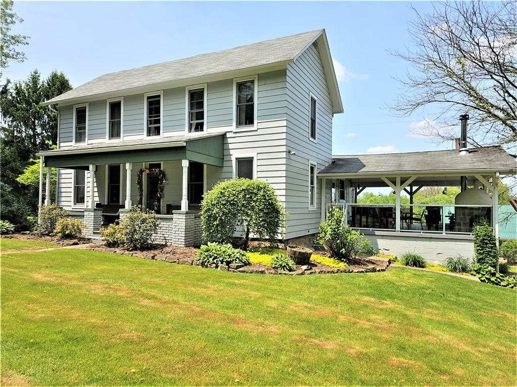 a view of a house with sitting area and garden