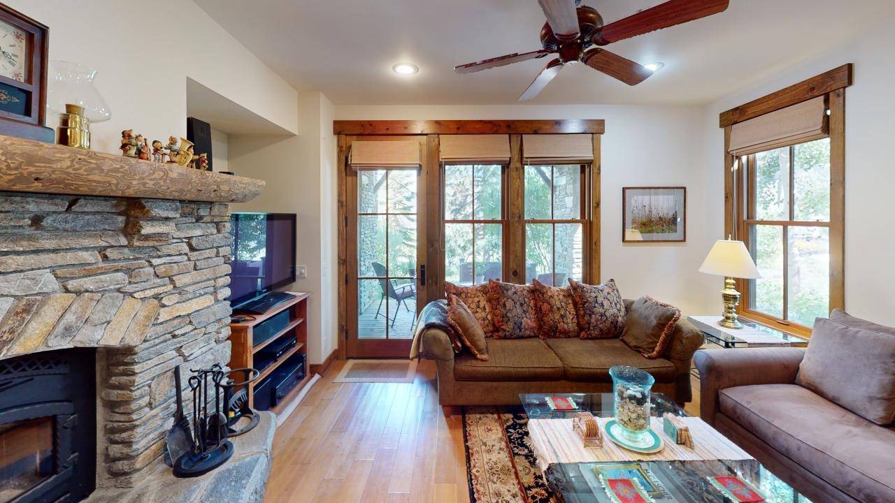 a living room with furniture a fireplace and a window