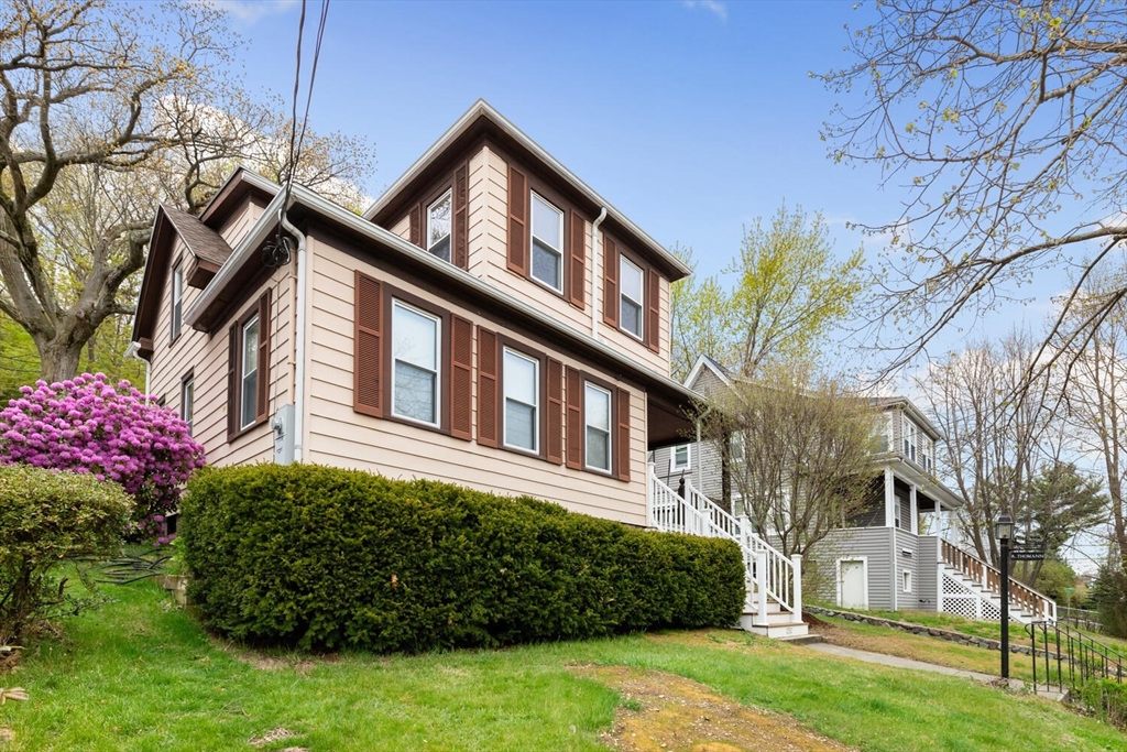 a front view of a house with a garden