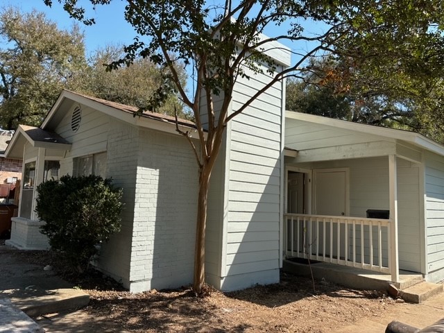 a view of a house with a tree