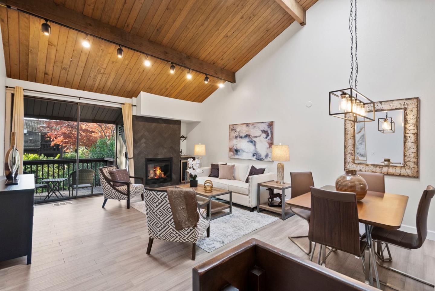 a living room with fireplace furniture and a floor to ceiling window