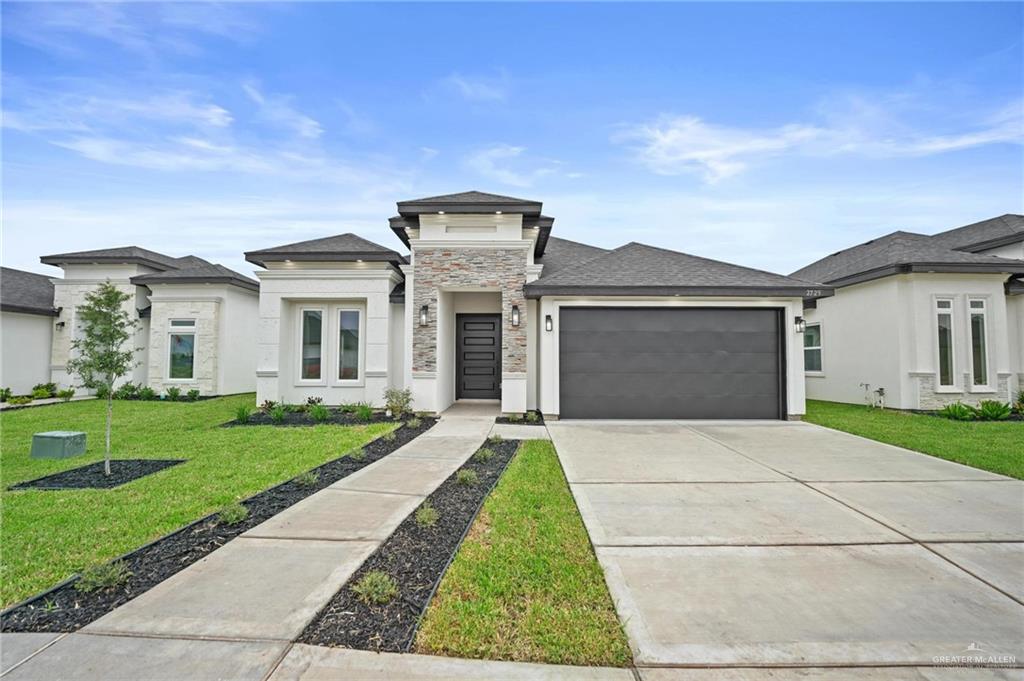 Prairie-style house with a front lawn and a garage