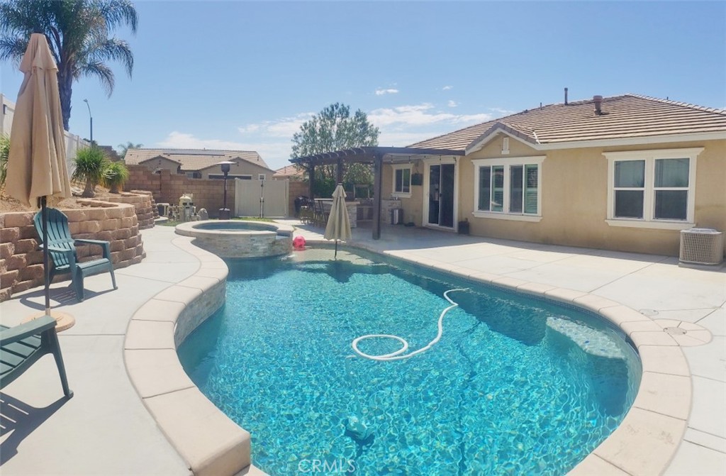 a view of a house with backyard porch and sitting area