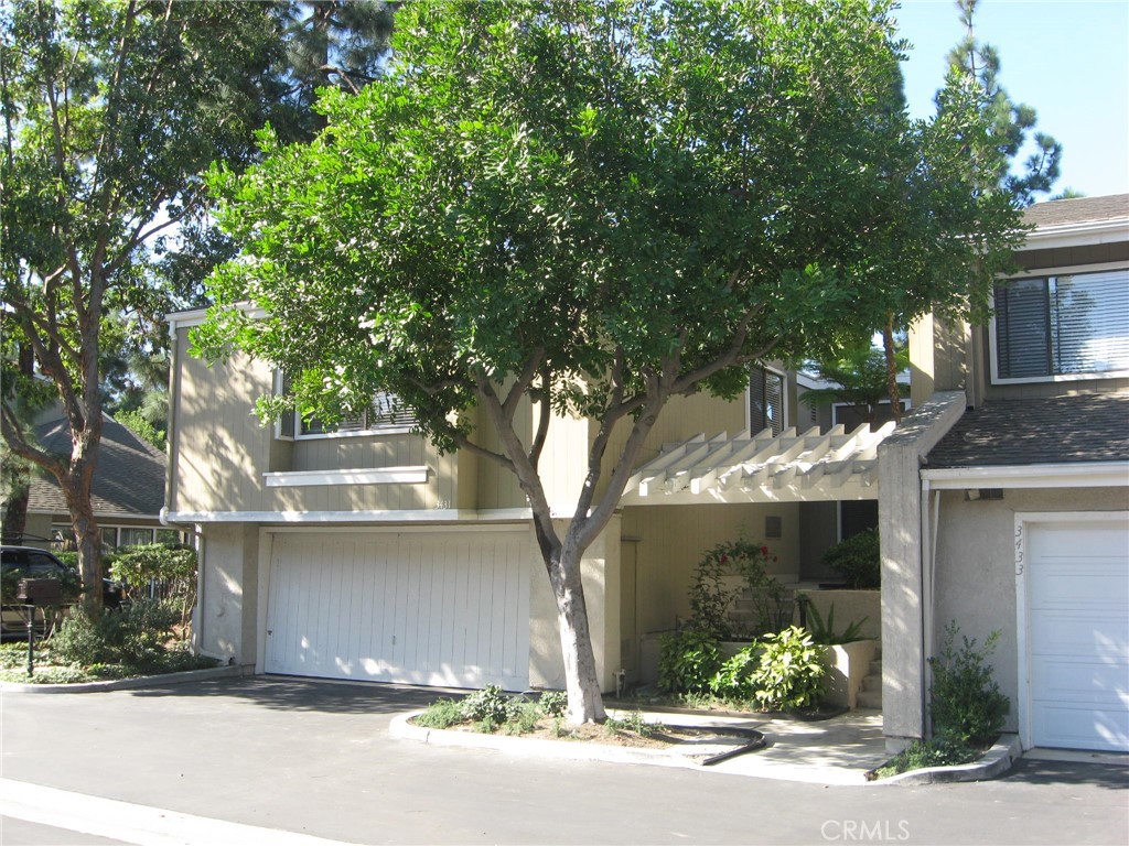 a front view of a house with a yard and a garage