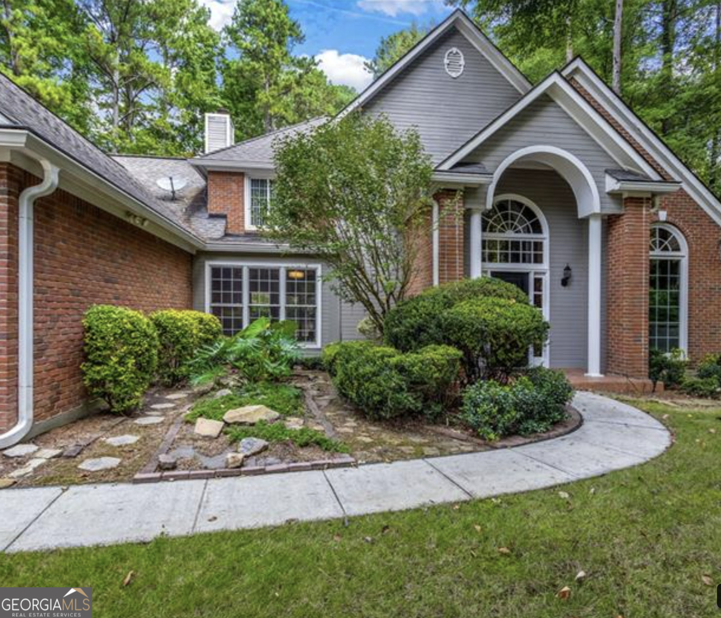 a front view of a house with garden