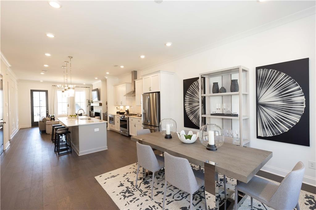 a large kitchen with a table and chairs