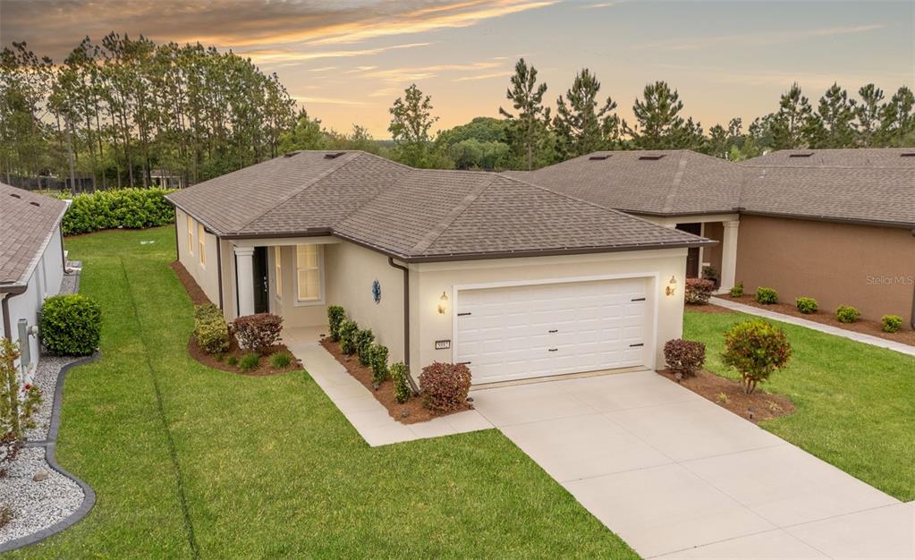 a aerial view of a house with yard porch and sitting area