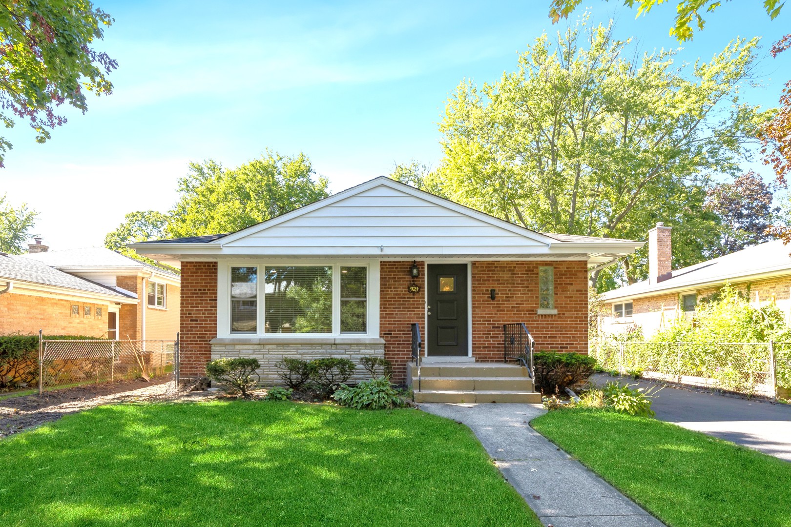 a front view of a house with a garden and yard