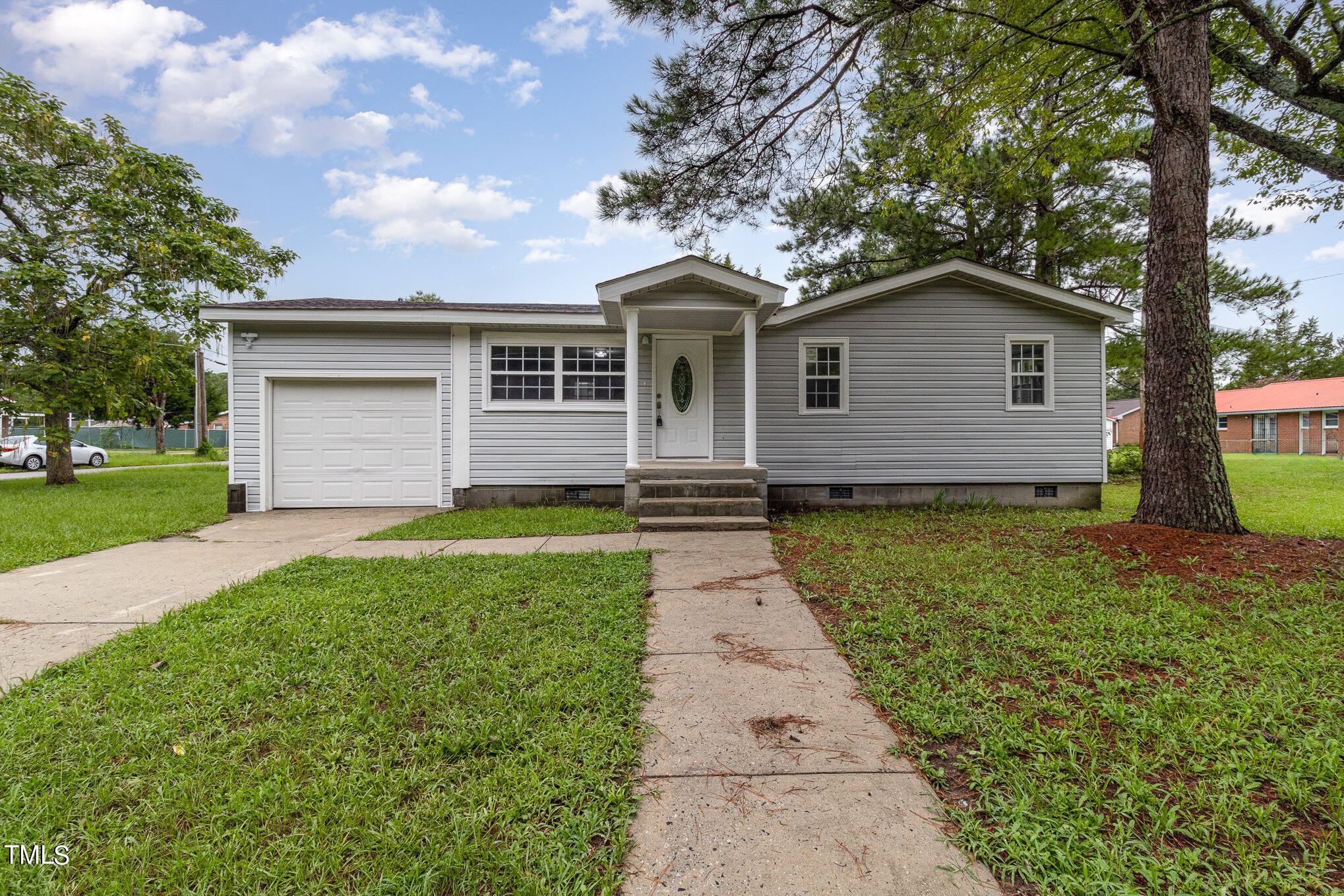 a front view of house with yard and green space