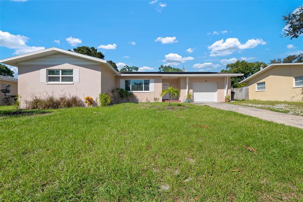 a front view of house with yard and green space