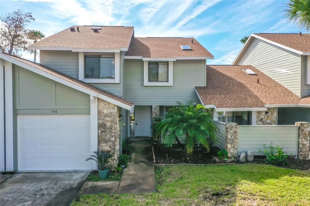 a front view of a house with a yard and garage