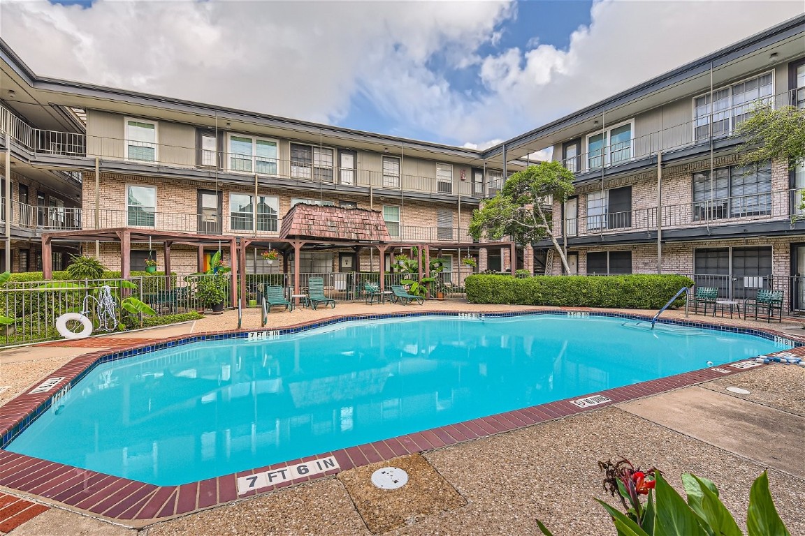 an outdoor view of swimming pool with an outdoor seating