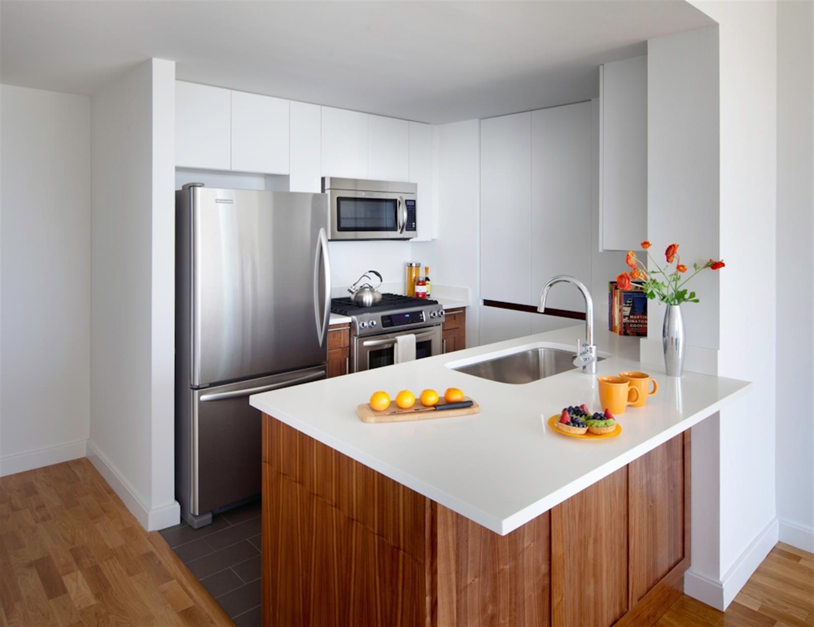 a kitchen with stainless steel appliances a refrigerator and a stove