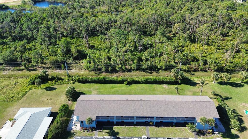 an aerial view of a house with a yard basket ball court and outdoor seating