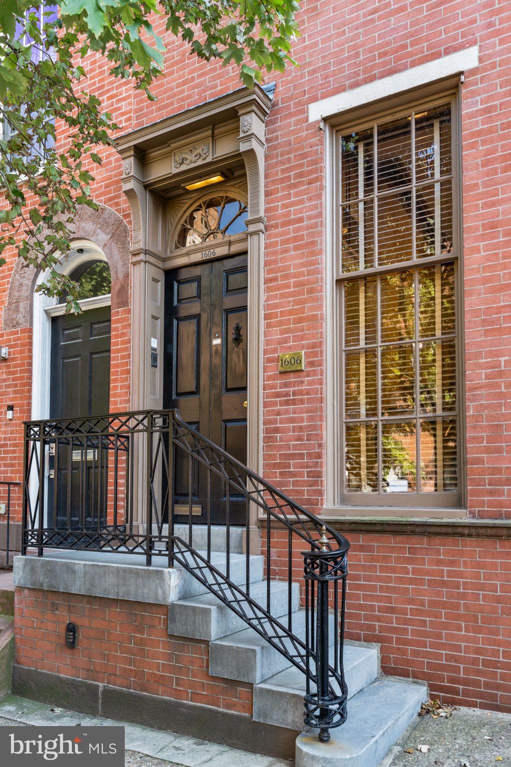 a view of a brick house with large windows