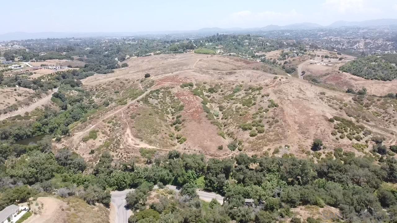 an aerial view of house with yard and mountain view in back