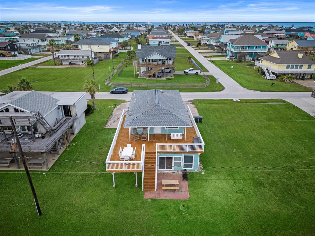 Aerial view of the coastal neighborhood Sea Isle and a clear view of the nearby ocean.