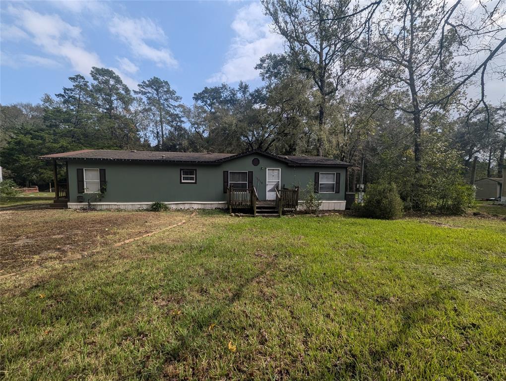 a front view of house with yard and green space