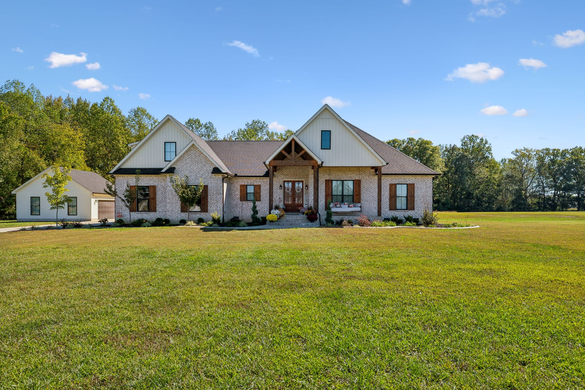 a front view of a house with yard and green space