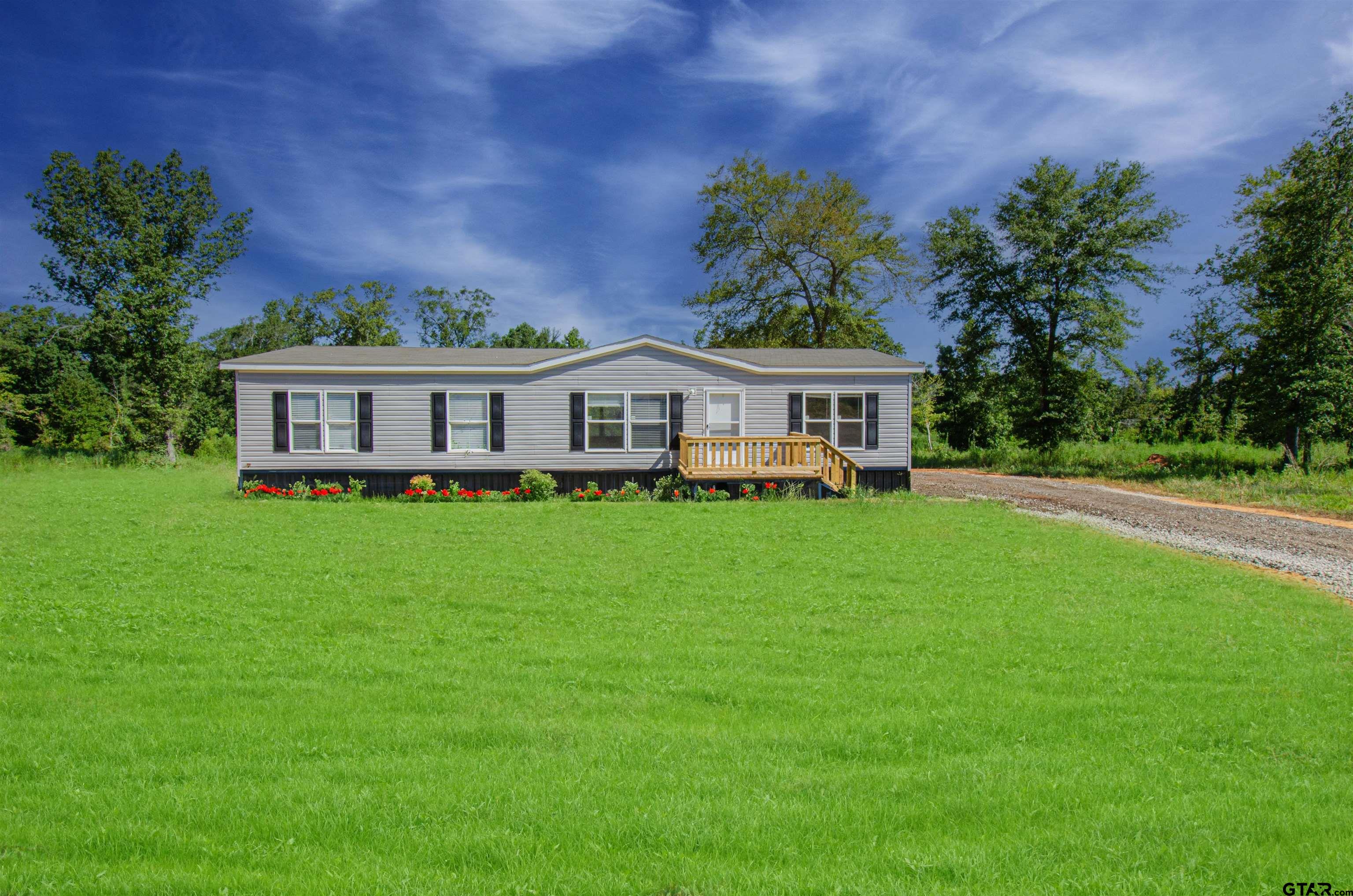 a view of a house with a big yard