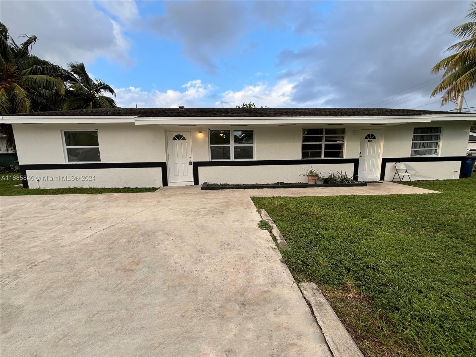 a front view of house with yard and seating area