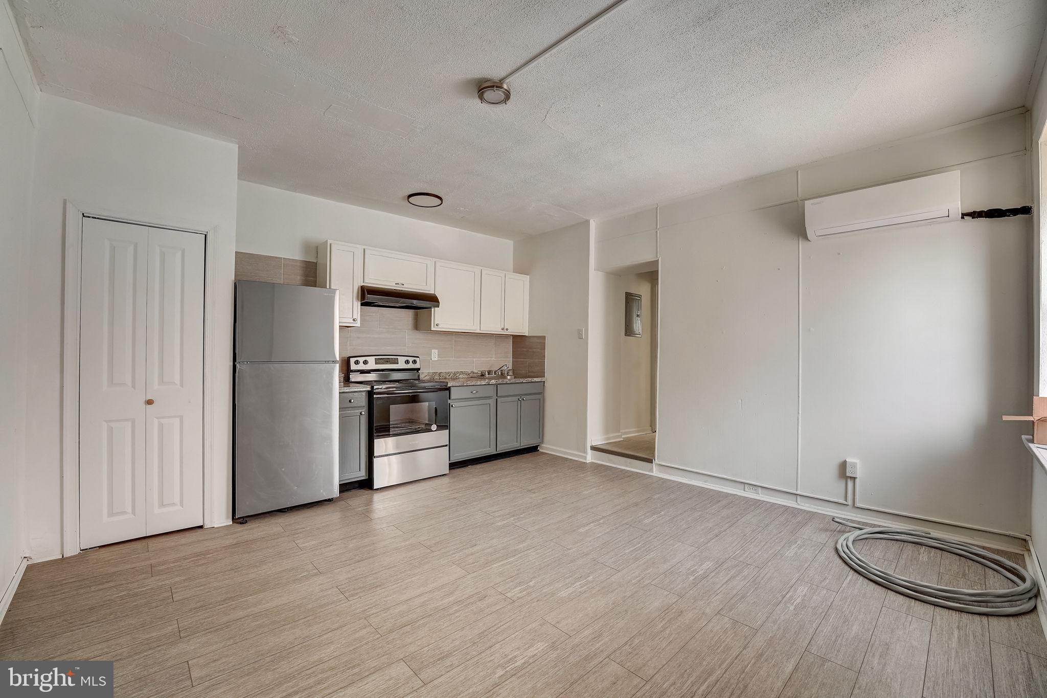 a kitchen with stainless steel appliances a refrigerator and a stove top oven