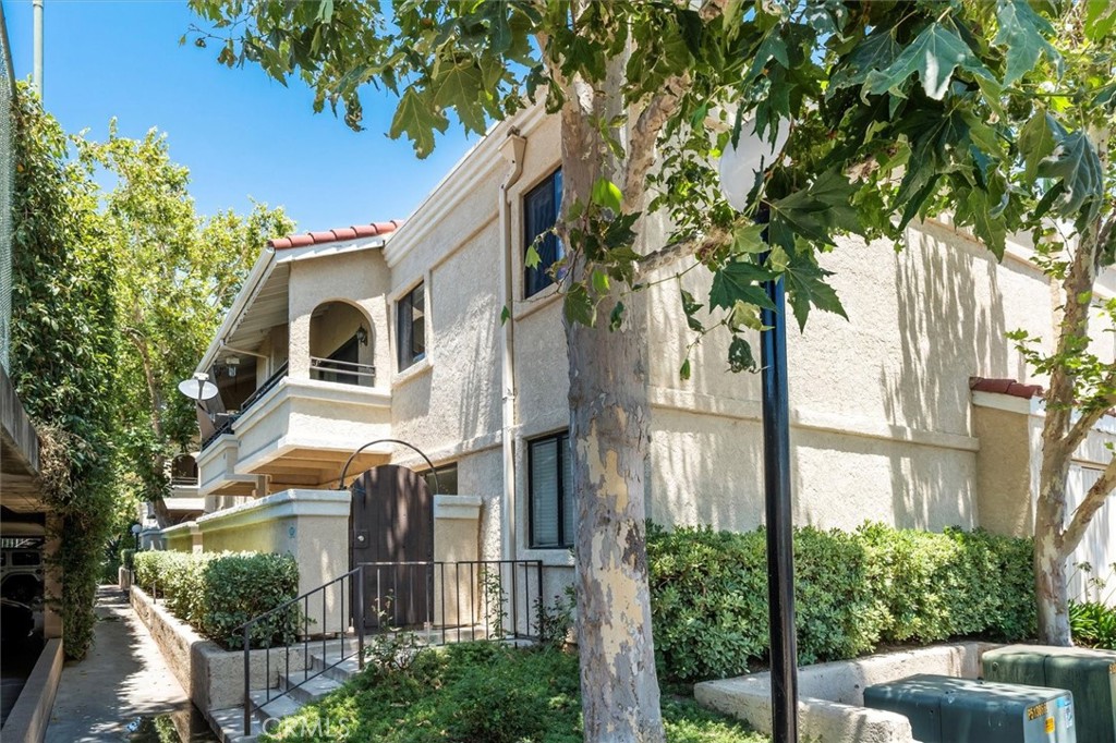 a front view of a house with a tree