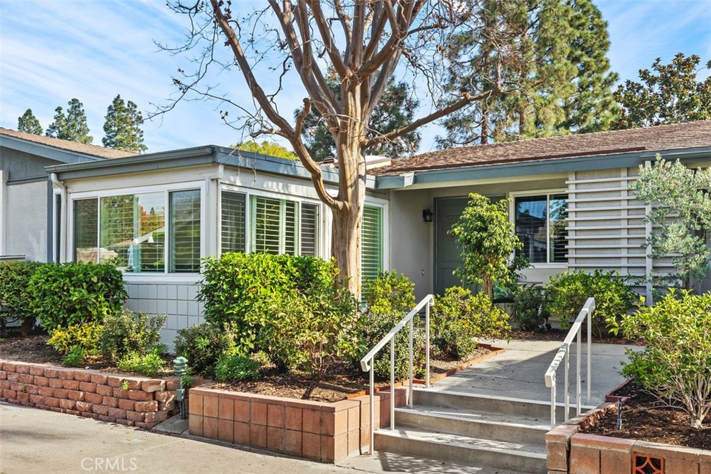 front view of a house with potted plants